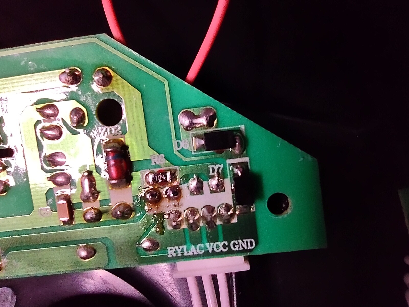 fresh solder joints on the back of the board showing debris and fresh melted flux. A relatively close-crowded set of pins surrounds the joints I had to rework for the capacitor.